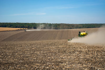 Scenic view of agricultural field against sky