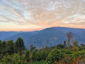 Scenic view of mountains against sky at sunset