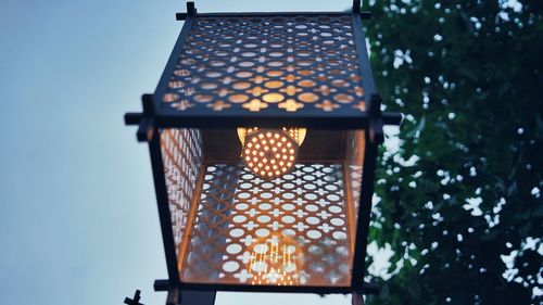 Low angle view of illuminated lamp against sky