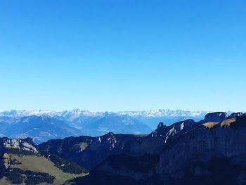 Scenic view of mountains against clear blue sky