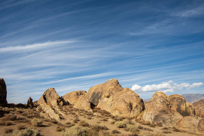 Rock formations in desert against blue sky