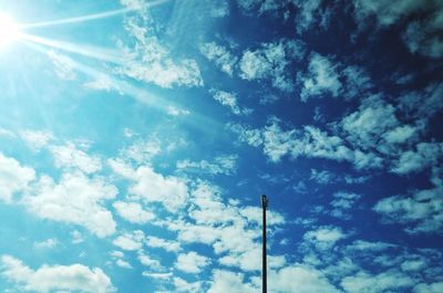 Low angle view of street light against blue sky