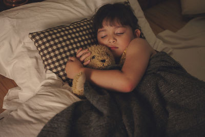 High angle view of baby sleeping on bed at home