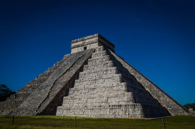 Low angle view of old building against blue sky