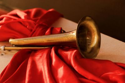 Close-up of trumpet on red textile