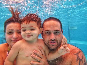 Portrait of family swimming in pool