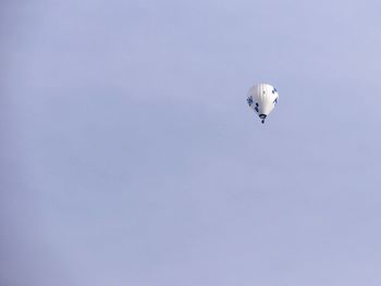 Low angle view of person paragliding against clear sky