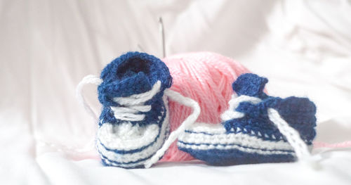 Close-up of baby booties on table