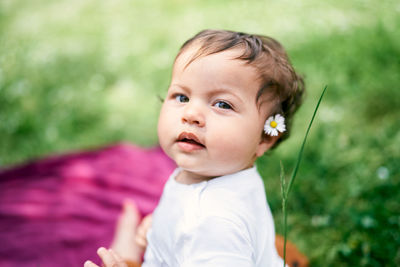 Portrait of cute baby boy looking away