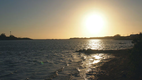 Scenic view of sea against clear sky during sunset