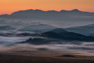 Scenic view of mountains against sky during sunset