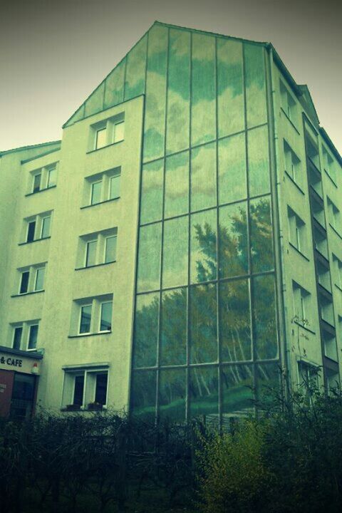 architecture, building exterior, built structure, low angle view, window, building, sky, glass - material, city, modern, residential building, office building, day, residential structure, no people, outdoors, reflection, tree, exterior, apartment