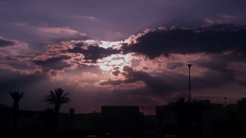 Silhouette of building against cloudy sky