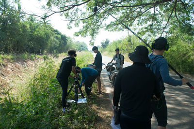 Rear view of people enjoying in forest