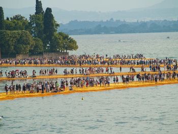 People on piers in sea