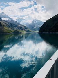 Scenic view of lake by mountains against sky