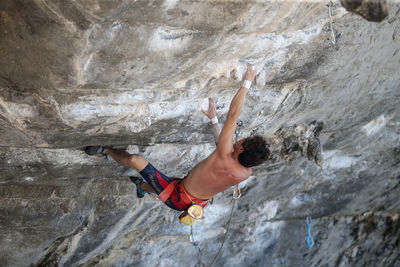 Midsection of person on rock at mountain