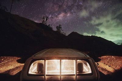 Scenic view of mountains against sky at night