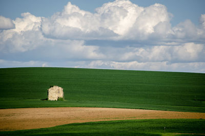 Scenic view of farm against sky