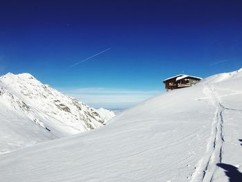 Snowcapped mountains against clear blue sky