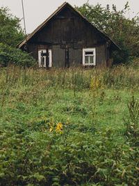 Abandoned house on field against sky