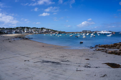 Scenic view of beach against blue sky