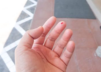 High angle view of blood on human finger