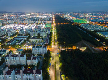 Aerial view of illuminated cityscape against sky