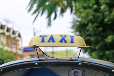 Close-up of taxi sign on car roof