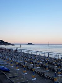 Scenic view of beach against clear blue sky