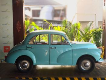 Vintage car on street against buildings in city