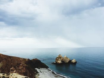 Scenic view of sea against cloudy sky