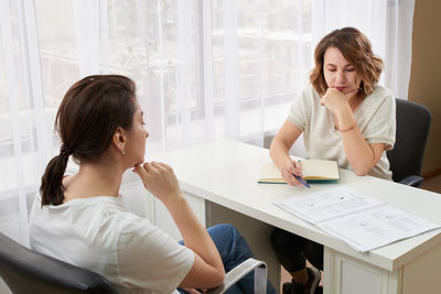 Businesswomen discussing business plan at office