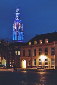 Illuminated building against sky at night