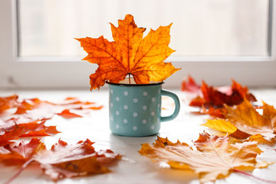 Autumn. fallen leaves and a rustic mug of warm tea