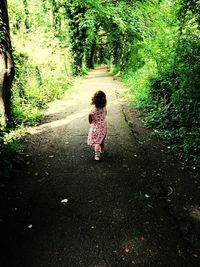 Full length of woman on footpath by road