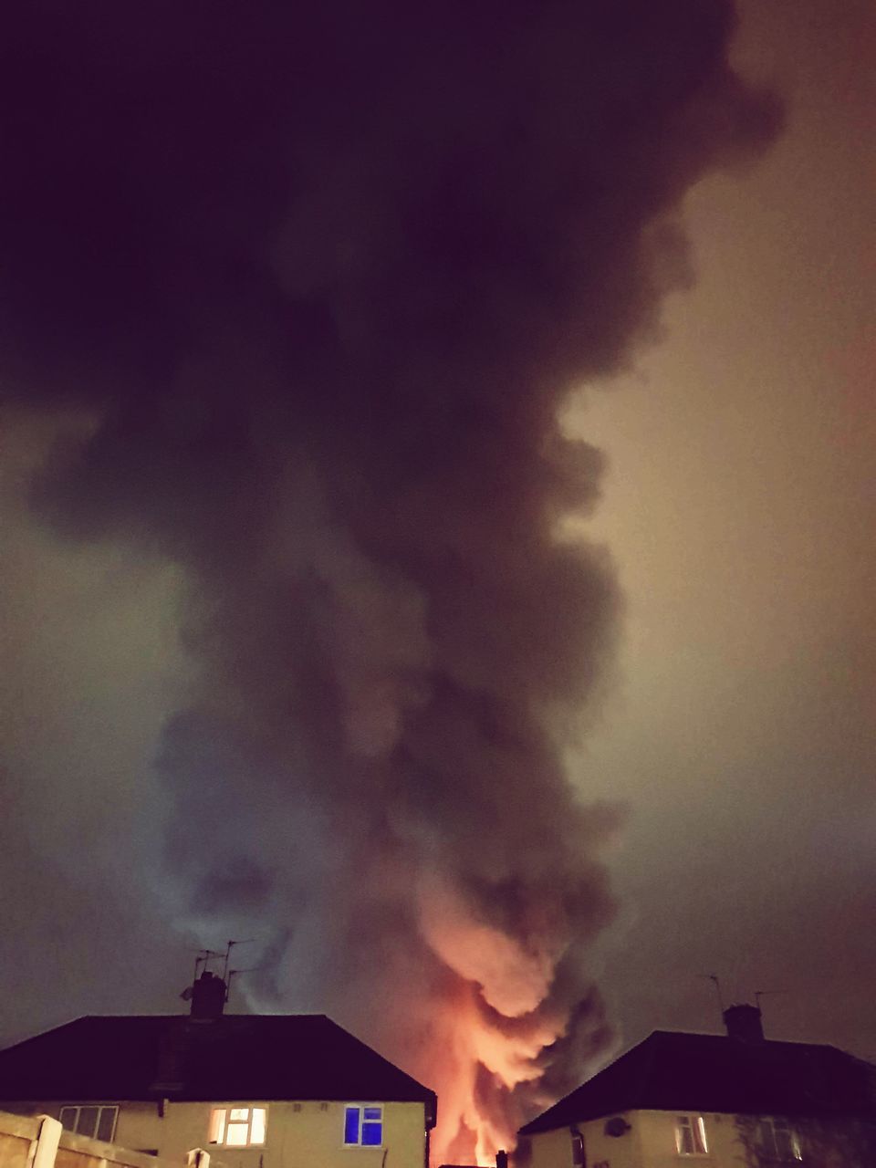 LOW ANGLE VIEW OF SMOKE STACKS AGAINST SKY