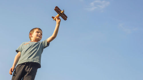 Low angle view of man standing against clear sky