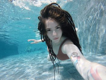 Portrait of woman swimming in sea