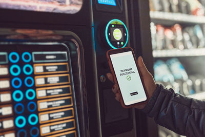 Consumer paying for product at vending machine using contactless method of payment with mobile phone