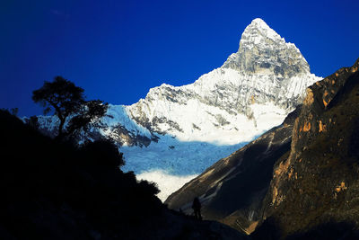 Low angle view of mountains against blue sky 