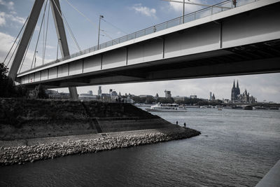 Bridge over river with city in background