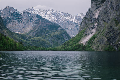 Scenic view of lake by mountains against sky