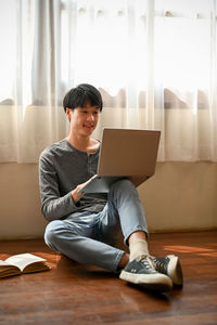 Young woman using laptop at home