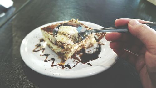 Close-up of cropped hand holding ice cream