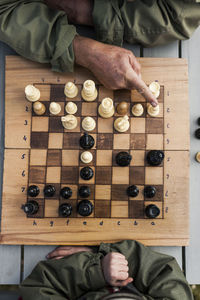 Boy with grandfather playing chess, high angle view