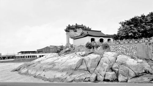 Built structures on beach against sky