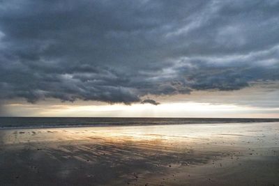 Scenic view of sea against storm clouds