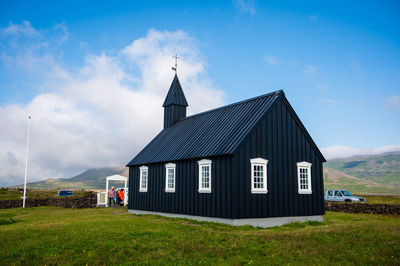 House on field against sky