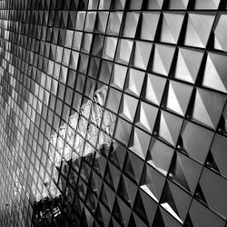Low angle view of modern glass building in city